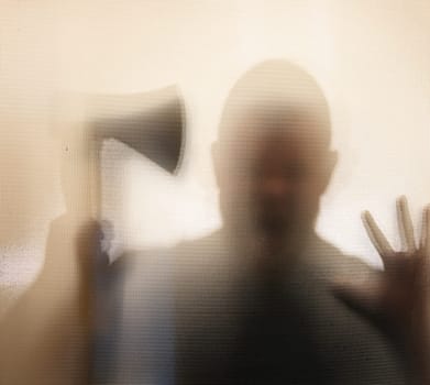 Horror, halloween background - Shadowy figure behind glass of a man holding an axe