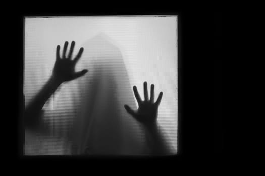 Horror, halloween background - Shadowy figure behind glass