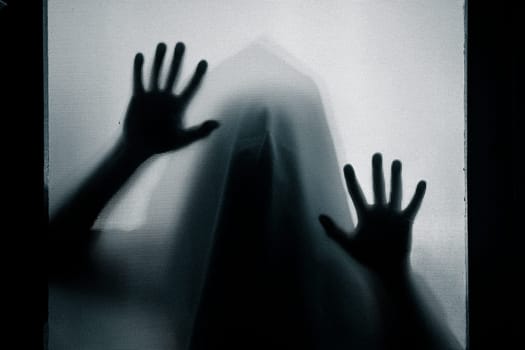 Horror, halloween background - Shadowy figure behind glass
