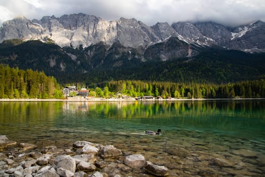 Faboulus landscape of Eibsee Lake with turquoise water in front of Zugspitze summit, Garmisch-Partenkirchen, Bavarian alps, Germany, Europe
