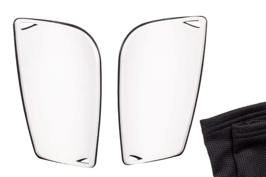 Football protection of the feet. Close-up of a pair of silver-grey striped padded shin guards isolated on a white background. Shinguards protect against fractures and bruises. Back view.