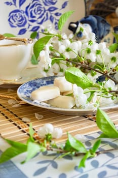 Homemade white chocolate bonbon candies. Tenderness morning coffee concept. Vertical image