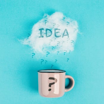 Cup of coffee with a steam cloud, pastel colors, brainstorming for ideas, creative business solution, question marks