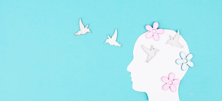 Silhouette of a woman with birds and flowers, greeting card with copy space, open mindset, creative portrait