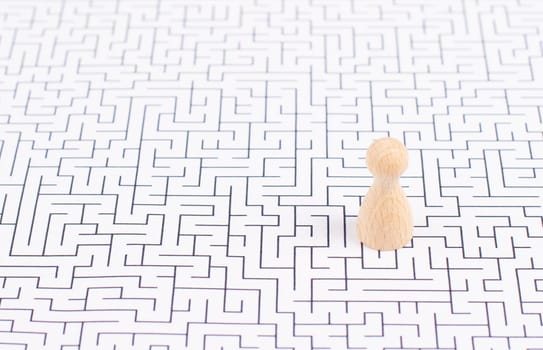 Man stands in the middle of a labyrinth, searching for a solution to exit, finding a strategy, challenge and problem solving concept