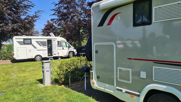 Campers parked on a Camer Van pitch. Concept camper van leisure and fun