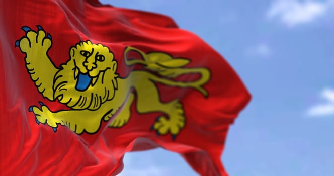 Rear view of the Aquitaine flag waving in the wind on a clear day. Aquitaine is a historical region of southwestern France and a former administrative region of the country. Selective focus