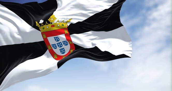 Rear view of Ceuta city flag waving in the wind on a clear day. Ceuta is a Spanish autonomous city on the north coast of Africa. Selective focus