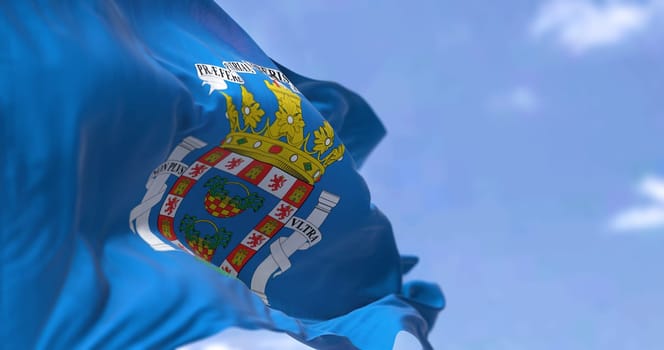 Rear view of Mellla city flag waving in the wind on a clear day. Melilla is one of two autonomous cities of Spain, located in north Africa country. Selective focus