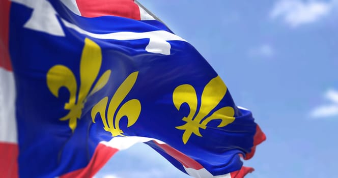 Rear view of the Centre Val de Loire flag waving in the wind on a clear day. Centre-Val de Loire is one of the eighteen administrative regions of France. Selective focus
