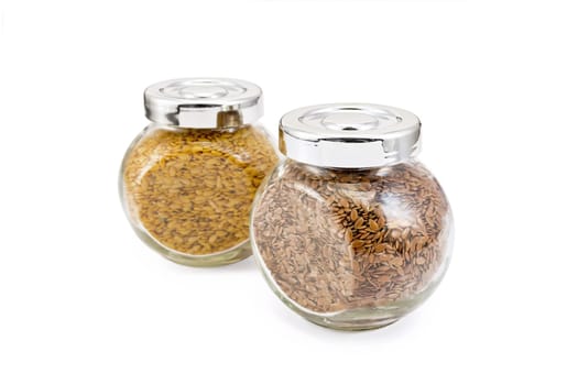 Flax seed white and brown in glass jars isolated on white background