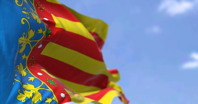 The Valencian Community flag waving in the wind on a clear day. The Valencian Community is an autonomous community of Spain. Seamless loop in slow motion
