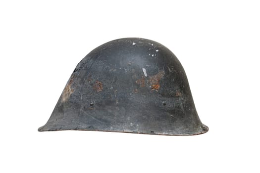 side view closeup of old black Second World War rusted metal helmet with traces of rust and cracks isolated on white background