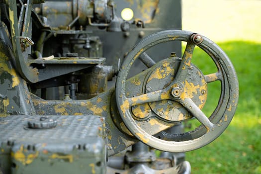 front view closeup of rusted guidance wheel on decommissioned artillery cannon
