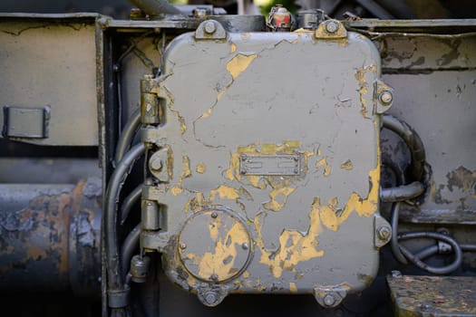 front view closeup of rusted metallic cabinet panel enclosure with peeled off paint