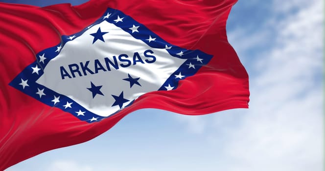 The state flag of Arkansas waving in the wind on a clear day. Democracy and independence. American state.