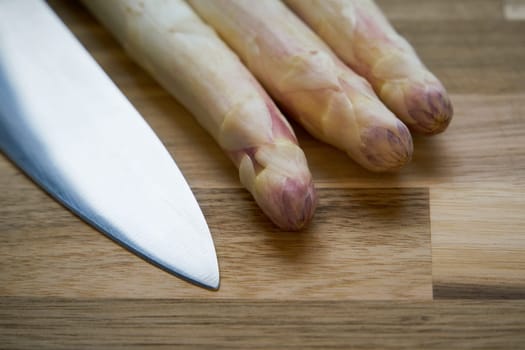 Fresh white asparagus directly from the field on a kitchen table