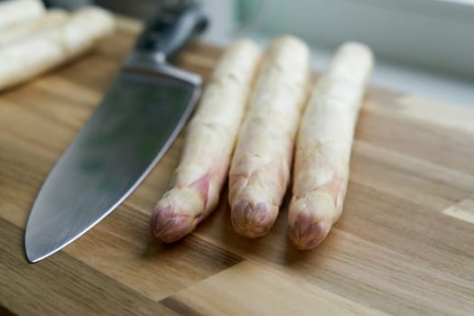Fresh white asparagus directly from the field on a kitchen table