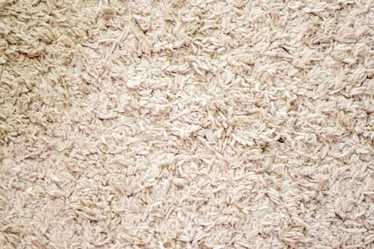 Beige background texture of towel or home carpet. Top view, flat lay. Textile texture of carpet. White or cream pile carpet. Stylish carpet on the floor in the room. Interior Design