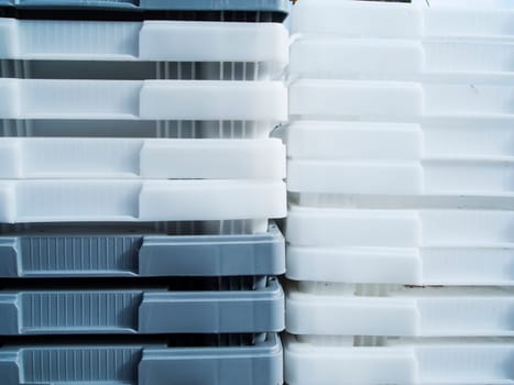 Close-up view of white and gray plastic containers stacked inside.