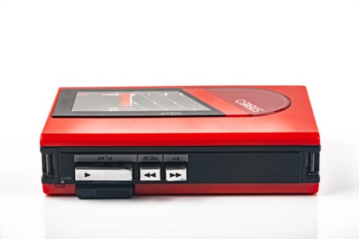 Beautiful red vintage audio cassette player over white background