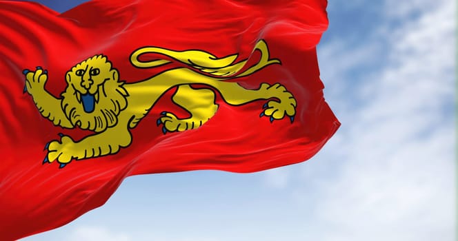 View of the Aquitaine flag waving in the wind on a clear day. Aquitaine is a historical region of southwestern France and a former administrative region of the country. Selective focus