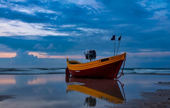 Sunset over Baltic Sea with empty fishing boat - Debki, Pomerania, Poland