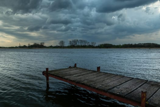 Footbridge over the lake and cloudy sky, Stankow, Poland