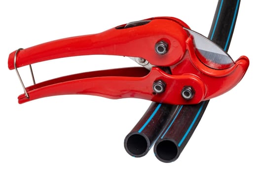 Plumber tools isolated. A red PVC pipe cutter for cutting plastic pipes and two pieces of PE pressure pipe or water pipe isolated on a white background. Space. Craftsman tools.