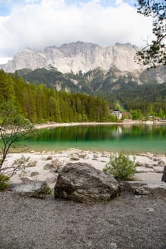 Faboulus landscape of Eibsee Lake with turquoise water in front of Zugspitze summit, Garmisch-Partenkirchen, Bavarian alps, Germany, Europe