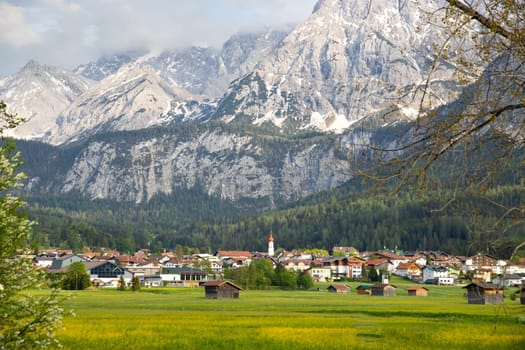 Small village in Austria with the Alps mountains in the background.