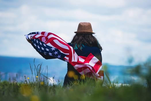 Young woman holding american USA flag. Independence Day or traveling in America concept.