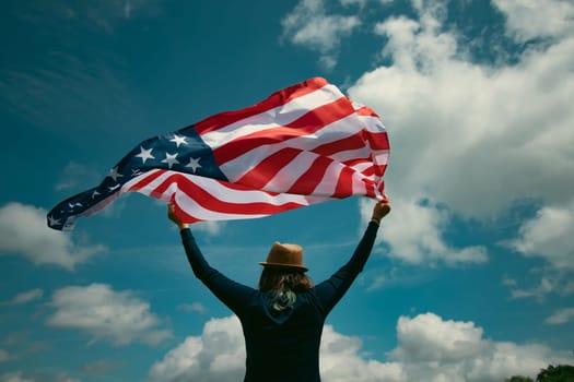 Young woman holding american USA flag. Independence Day or traveling in America concept.