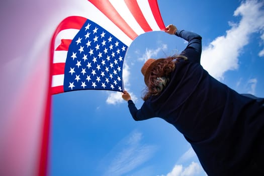 Young woman holding american USA flag. Independence Day or traveling in America concept.