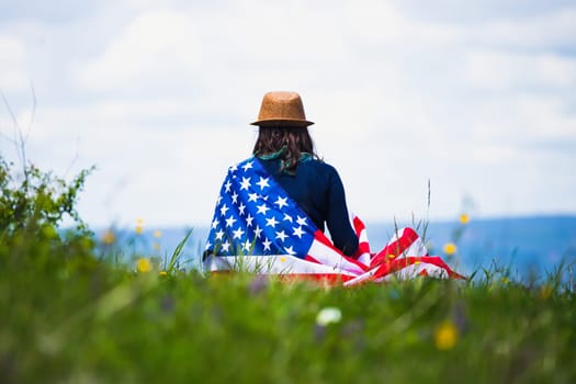 Young woman holding american USA flag. Independence Day or traveling in America concept.