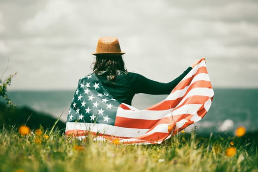 Young woman holding american USA flag. Independence Day or traveling in America concept.