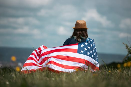 Young woman holding american USA flag. Independence Day or traveling in America concept.