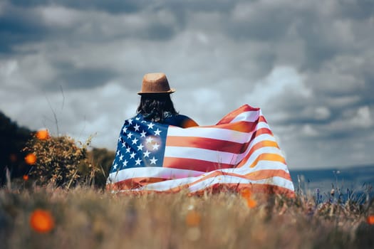 Young woman holding american USA flag. Independence Day or traveling in America concept.