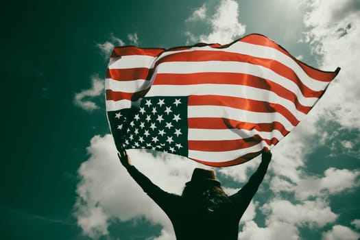 Young woman holding american USA flag. Independence Day or traveling in America concept.