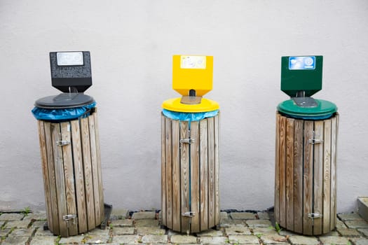 Metal containers for different garbage with an inscription in german. Separation and sorting of rubbish