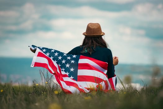 Young woman holding american USA flag. Independence Day or traveling in America concept.
