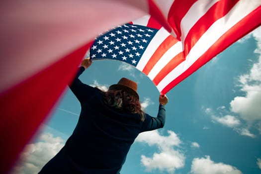 Young woman holding american USA flag. Independence Day or traveling in America concept.