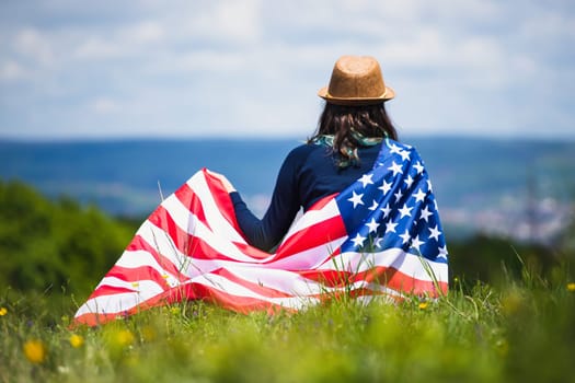 Young woman holding american USA flag. Independence Day or traveling in America concept.