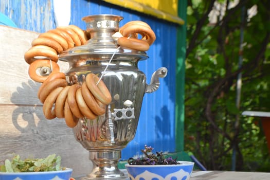 Russian samovar and a lot of bagels close up. Bright summer day