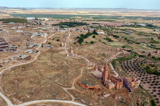 a view of the remains of the old town of Belchite, Zaragoza Spain, destroyed during the Spanish Civil War and abandoned from then, highlighting the San Martin de Tours church, panoramic overview