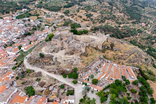 The ancient castle of montanchez near Caceres, Extremadura, Spain, freely accessible to tourists, is situated on top of a mountain and offers a beautiful panoramic view of the landscape. Aerial view from above