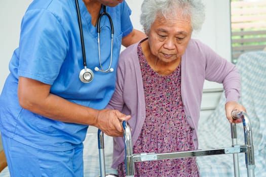 Doctor help Asian elderly woman disability patient in nursing hospital, medical concept.