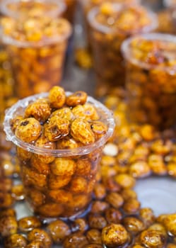 Glasses with tiger nuts or chufas. Water drops falling on cups displayed at street market stall