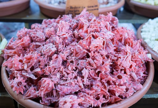 Dried hibiscus flowers. Slices displayed at street market stall