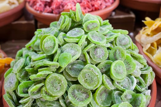 Bowl with dried kiwifruit. Slices displayed at street market stall